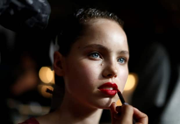 A model has her lipstick applied before a runway show in Australia. A new study has found potentially harmful chemicals called PFAS in makeup. (Jason Reed/Reuters - image credit)