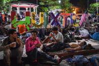 Thousands of migrants in a caravan marching towards the US rest in the Mexican town of Huixtla -- most have been walking for days, and are nursing various injuries