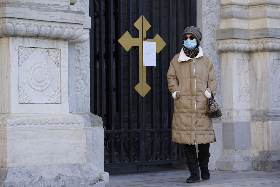 A visitor wearing mask to protect from the coronavirus walks by a closure notice outside outside the Wangfujing Church in Beijing on Friday, Dec. 25, 2020. Official churches in the Chinese capital abruptly cancelled mass on Christmas day in a last-minute move owing to the pandemic. The capital city is on high alert after new confirmed COVID-19 cases were reported last week and new asymptomatic cases reported Christmas day. (AP Photo/Ng Han Guan)