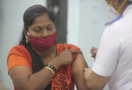 A health worker receives a COVID-19 vaccine at a government Hospital in Mumbai, India, Tuesday, Jan 19, 2021. India's homegrown vaccine developer Bharat Biotech has warned people with weaker immunity and other medical conditions that include allergies, fever, or a bleeding disorder to consult a doctor before getting the shot — and if possible avoid the vaccine. (AP Photo/Rafiq Maqbool)