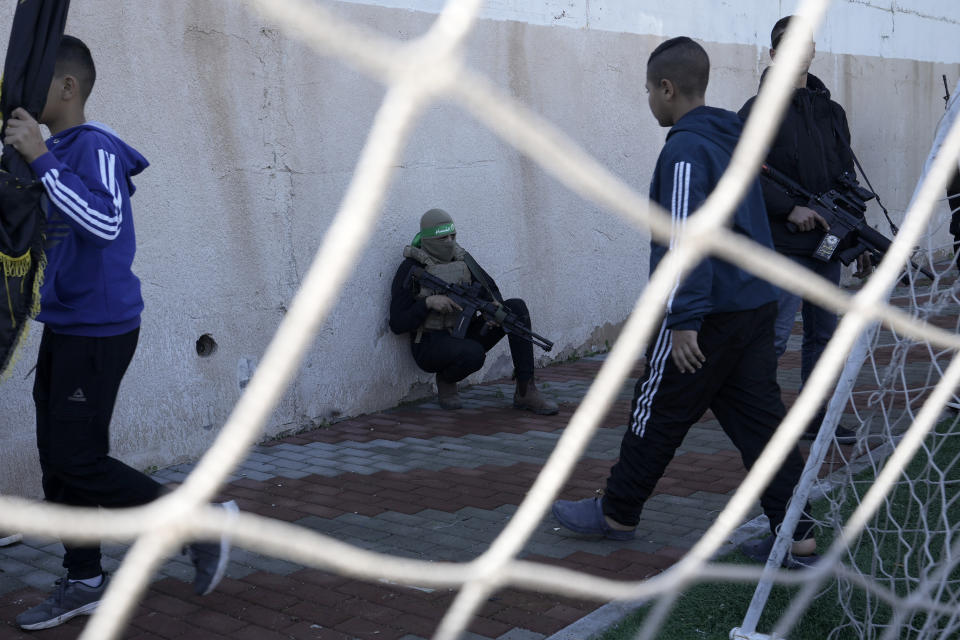 Palestinian gunmen take part in the funeral of Jawad Bawaqna, 57, and Adham Jabareen, 28, in the in the West Bank city of Jenin, Thursday, Jan. 19, 2023. Palestinian officials and media reports say Israeli troops shot and killed the Palestinian schoolteacher and a militant during a military raid in the occupied West Bank. (AP Photo/Majdi Mohammed)