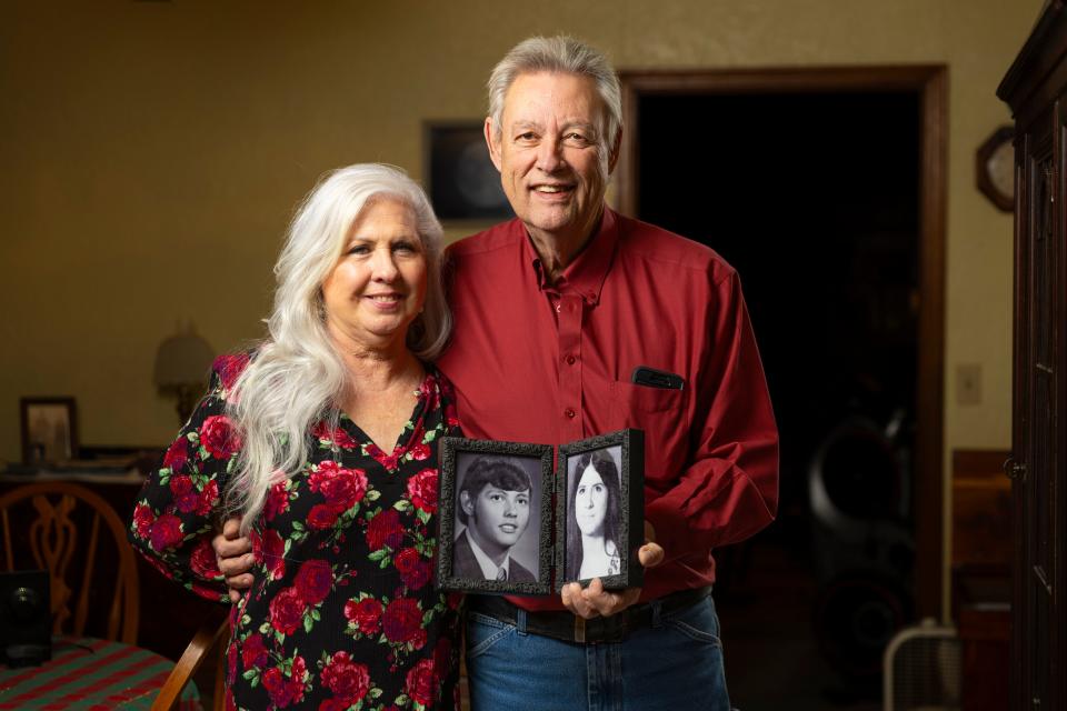 Tom Miller, right, and Theresa Rowell hold old photos of themselves Jan. 5 as they pose for a photo in Norman.