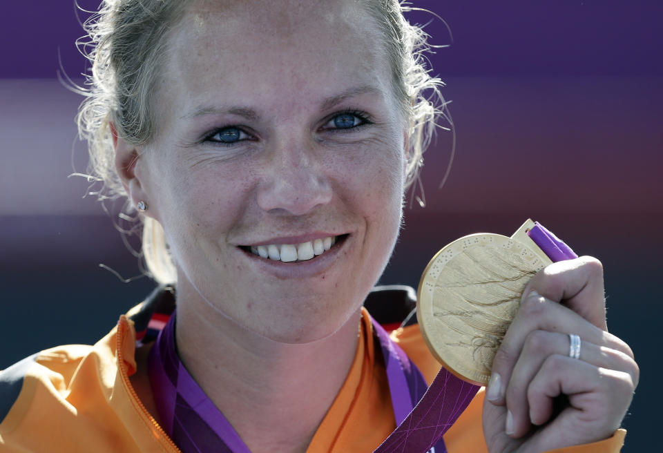 FILE - Esther Vergeer of the Netherlands holds her gold medal for winning the women's wheelchair tennis final at the 2012 Paralympics games, Friday, Sept. 7, 2012, in London. Wheelchair tennis star Esther Vergeer will be inducted into the International Tennis Hall of Fame on Saturday, July 22. (AP Photo/Alastair Grant, File)