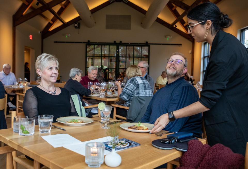Patti and Sam Phillips, of Brighton, receive their second dish in a multi-course dinner served during a Detroit Free Press Top 10 Takeover dinner event at the Dixboro Project in Ann Arbor on Tuesday, Sept. 27, 2022.