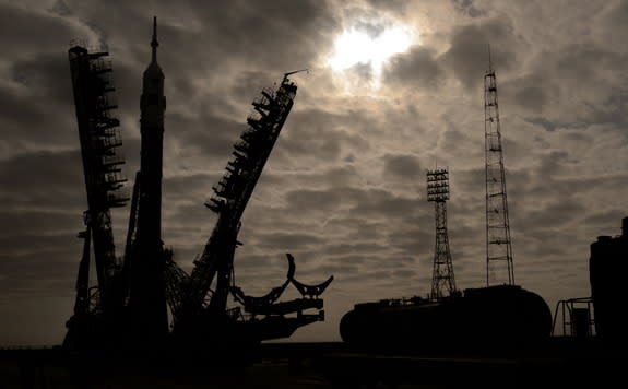 The gantry arms begin to close around the Soyuz TMA-12M spacecraft to secure the rocket at the launch pad on Sunday, March 23, 2014, at the Baikonur Cosmodrome in Kazakhstan. Launch of the Soyuz rocket is scheduled for March 26 and will send Ex