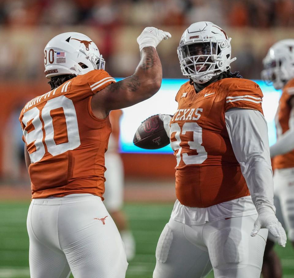 Texas Longhorns defensive lineman T'Vondre Sweat (93) and Texas Longhorns defensive lineman Byron Murphy II (90) celebrate a play during the game against Texas Tech at Darrell K Royal Texas Memorial Stadium on Friday, Nov. 24, 2023.