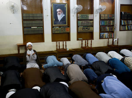 Shi'ite clerics pray at Sadiq Hussaini Shirazi's office who is a top Shi'ite cleric in Kerbala, Iraq, July 30, 2017. REUTERS/Abdullah Dhiaa Al-deen