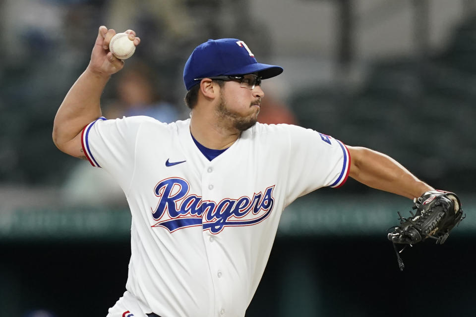 Texas Rangers starting pitcher Dane Dunning throws during the first inning of the team's baseball game against the Houston Astros in Arlington, Texas, Tuesday, June 14, 2022. (AP Photo/LM Otero)