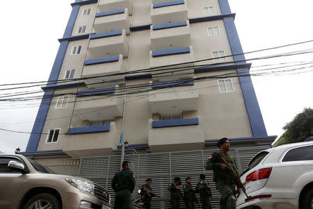 Cambodia police stand at a condo where they arrested dozens of young Chinese men and women working on a call centre to carry out a telephone and internet scam on victims in China in Phnom Penh, Cambodia, August 18, 2017. REUTERS/Samrang Pring