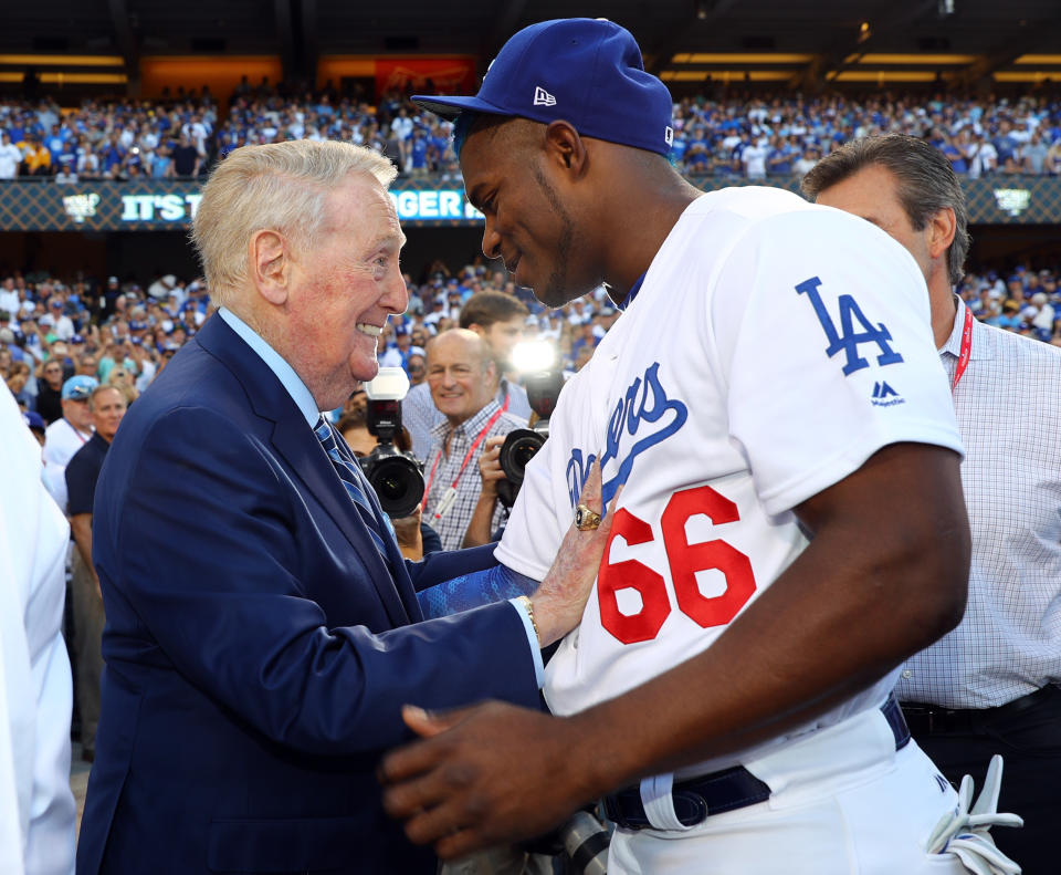 <p>Hall of Fame broadcaster Vin Scully talks to Yasiel Puig #66 of the Los Angeles Dodgers before Game 2 of the 2017 World Series against the Houston Astros at Dodger Stadium on Wednesday, October 25, 2017 in Los Angeles, California. (Photo by Alex Trautwig/MLB Photos via Getty Images) *** Local Caption *** Vin Scully, Yasiel Puig </p>