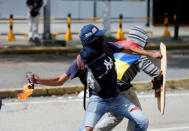 Demonstrators clash with riot security forces while rallying against Venezuela's President Nicolas Maduro's government in Caracas, Venezuela, July 28, 2017. REUTERS/Andres Martinez Casares