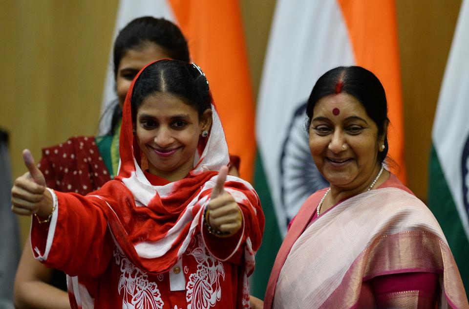 File Photo: Geeta (L) gestures as she stands alongside Sushma Swaraj after a press conference in New Delhi on October 26, 2015. (SAJJAD HUSSAIN/AFP via Getty Images)