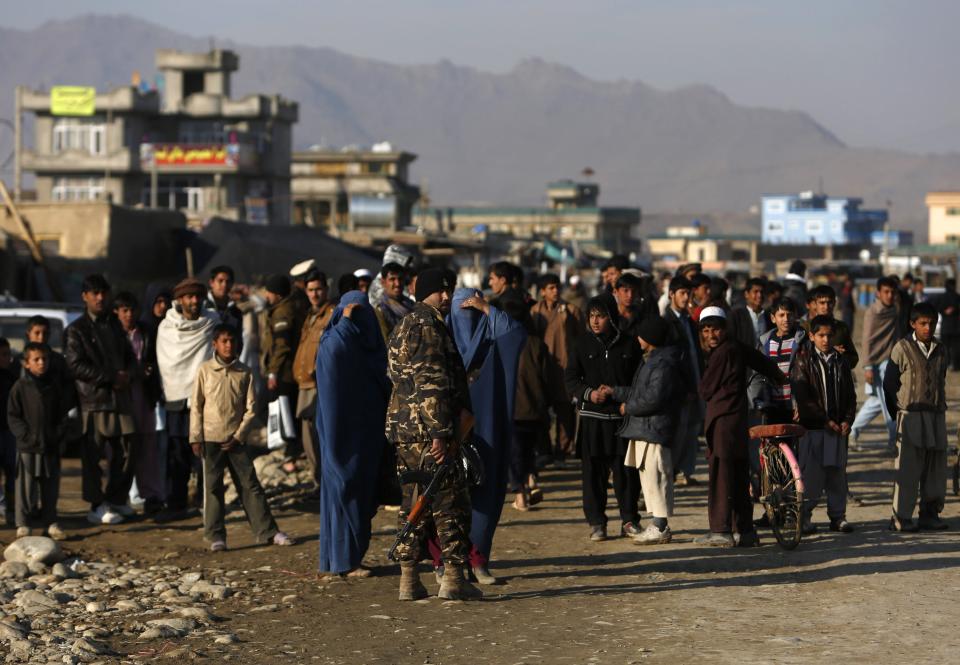 Afghan soldiers secure an area at the site of a suicide car bomb attack in Kabul