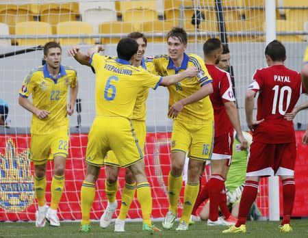 Ukraine's Denys Garmash (3rd L) and team mates celebrate his goal against Luxembourg during their Euro 2016 Group C qualifying soccer match at the Arena Lviv stadium in Lviv, Ukraine, June 14, 2015. REUTERS/Gleb Garanich