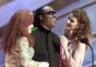 <p>LOS ANGELES, UNITED STATES: Singers Bonnie Raitt (L), Stevie Wonder (C) and Celine Dion (R) smile as they present the Record of the Year award during the 44th Annual Grammy Awards in Los Angeles, 27 February 2002. AFP PHOTO/Hector MATA (Photo credit should read HECTOR MATA/AFP via Getty Images)</p> 