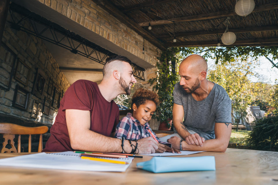 Male couple learning their daughter math