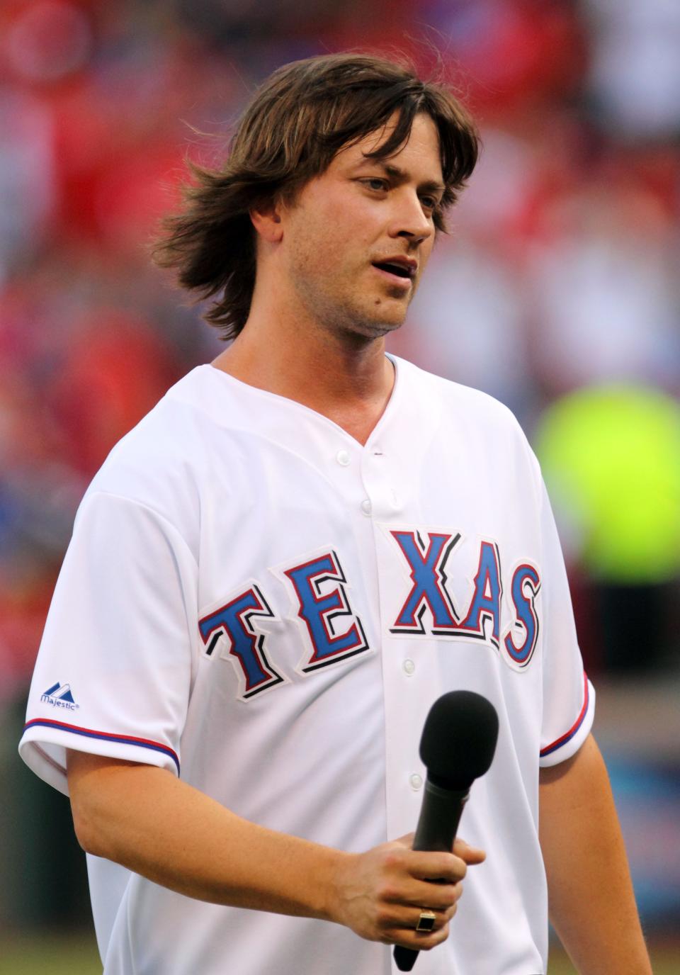 Rhett Miller of the band The Old 97's sings the national anthem before the first inning of a 2011 game between the Texas Rangers and the Toronto Blue Jays at Rangers Ballpark.