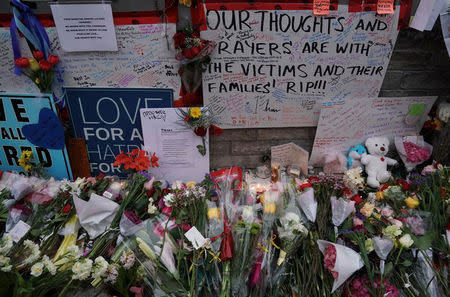 Flowers and messages are left by mourners at a makeshift memorial a day after a van struck multiple people along a major intersection in north Toronto, Ontario, Canada, April 24, 2018. REUTERS/Carlo Allegri