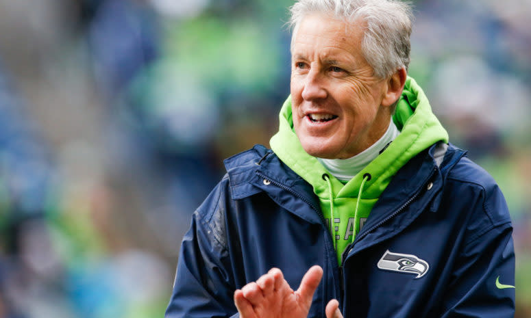 A closeup of Seattle Seahawks coach Pete Carroll clapping.