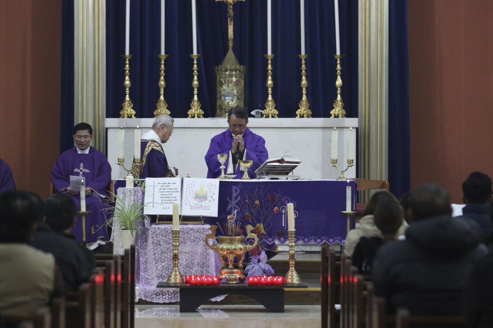Father Simon Thang Duc Nguyen, center, leads the congregation in prayer during a Mass and vigil for the 39 victims found dead inside the back of a truck in Grays, Essex, at The Holy Name and Our Lady of the Sacred Heart Church, east London's Vietnamese church on Saturday, Nov. 2, 2019. All those killed were Vietnamese nationals, British police said. (Yui Mok/PA via AP)