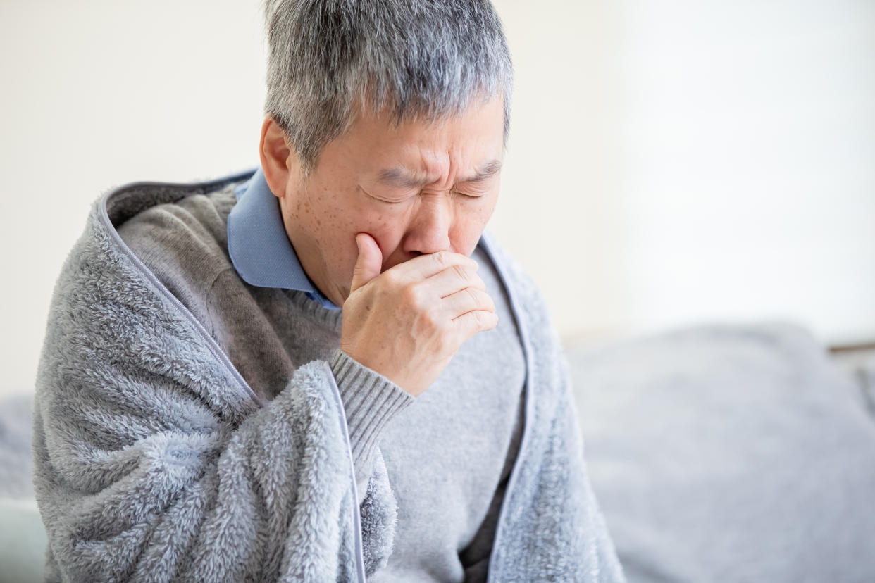 asian eldely sick man has a cold and cough at home