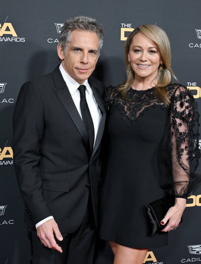 The couple smile as they pose together for a photo at a red carpet event