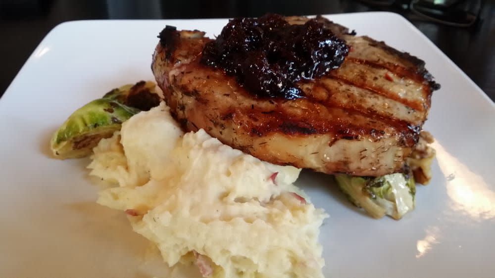 Pork chop with compote and mashed potatoes at Merchants Pub + Plate