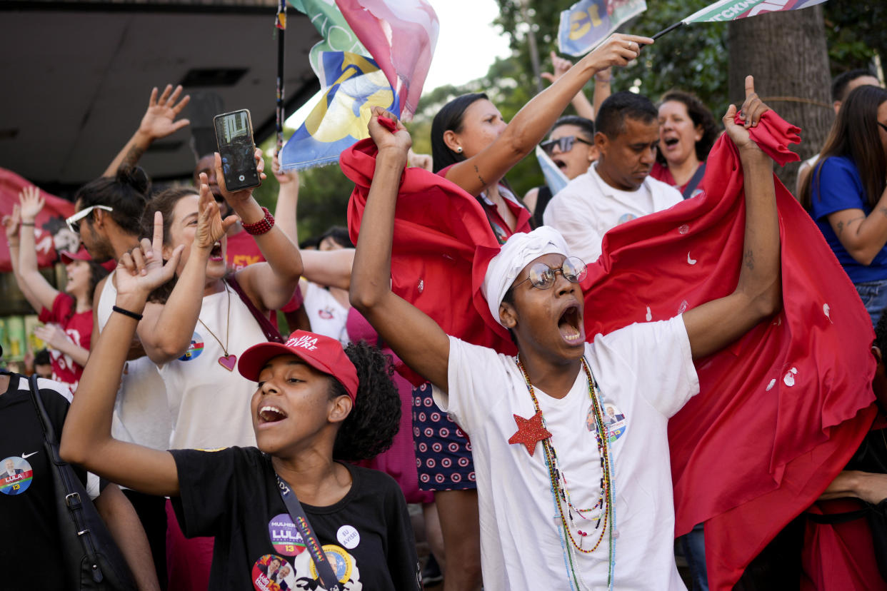 Supporters of Brazil's former President Luiz Inacio Lula da Silva, who is running for president again, rally after the closing of the polls for a presidential run-off election in Sao Paulo, Brazil, Sunday, Oct. 30, 2022. (AP Photo/Matias Delacroix)