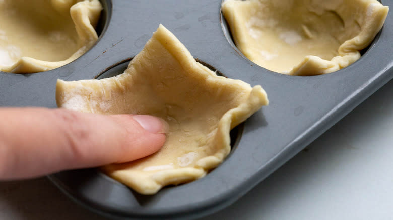 puff pastry pieces in muffin tin