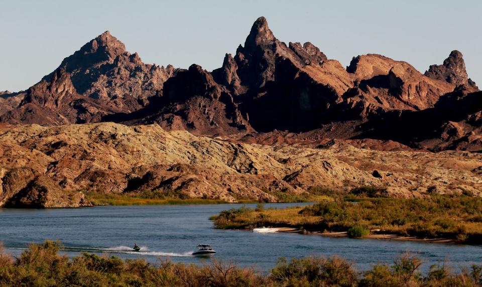 Boaters cross the Arizona-California border on the Colorado River near Needles.