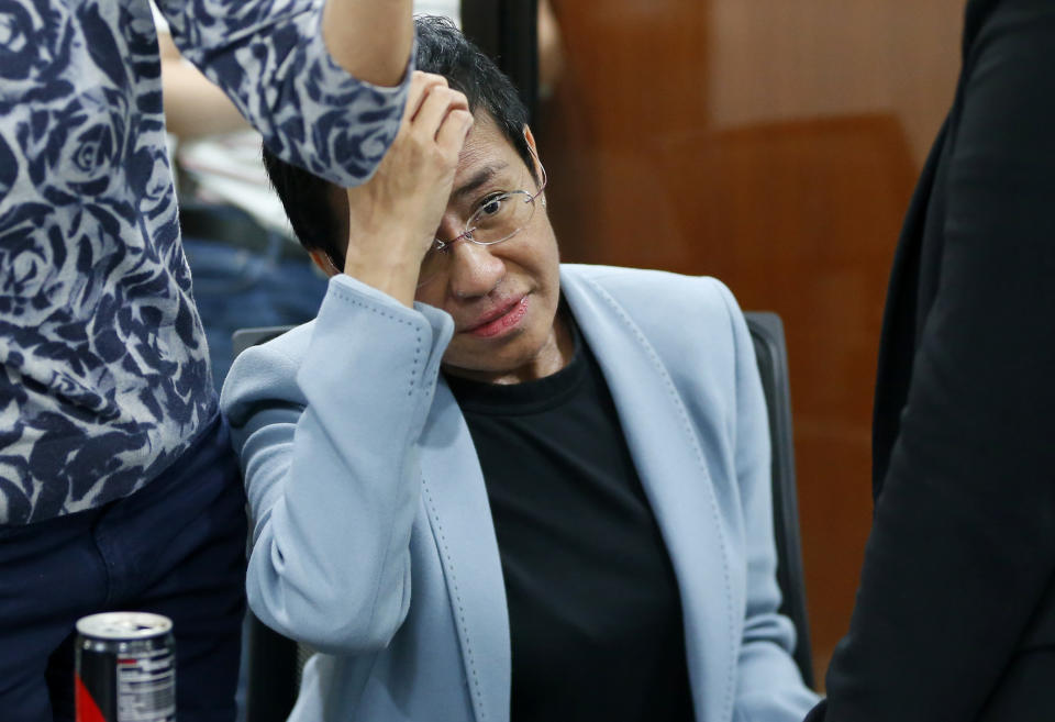 Maria Ressa, the award-winning head of a Philippine online news site Rappler that has aggressively covered President Rodrigo Duterte's policies, shows an arrest form after being arrested by National Bureau of Investigation agents in a libel case Wednesday, Feb. 13, 2019 in Manila, Philippines. Ressa, who was selected by Time magazine as one of its Persons of the Year last year, was arrested over a libel complaint from a businessman which Amnesty International has condemned as "brazenly politically motivated." Duterte's government says the arrest was a normal step in response to the complaint. (AP Photo/Bullit Marquez)
