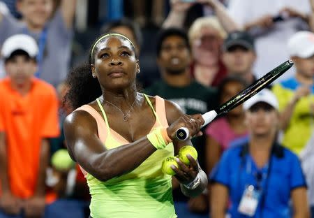 Aug 22, 2015; Cincinnati, OH, USA; Serena Williams (USA) hits tennis balls into the stands after defeating Elina Svitolina (not pictured) in the semifinals during the Western and Southern Open tennis tournament at the Linder Family Tennis Center. Mandatory Credit: Aaron Doster-USA TODAY Sports