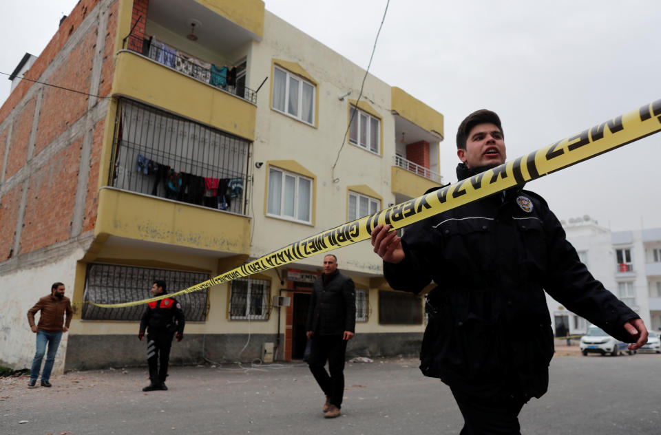 <p>A Turkish police officer secures the area after a building was hit by a rocket fired from Syria, in the border town of Kilis, Turkey, Jan. 22, 2018. (Photo: Osman Orsal/Reuters) </p>