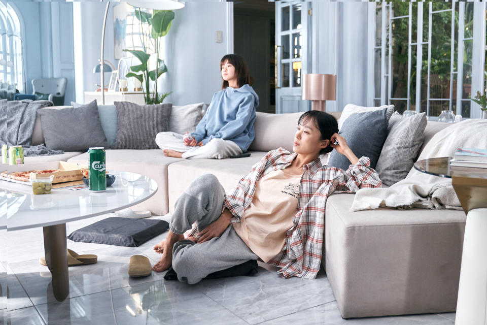 Mother and daughter Gil Jae-young (Kim Si-A) and Gil Boksoon (Jeon Do-yeon) watch the news together.<span class="copyright">No Ju-han—Netflix</span>