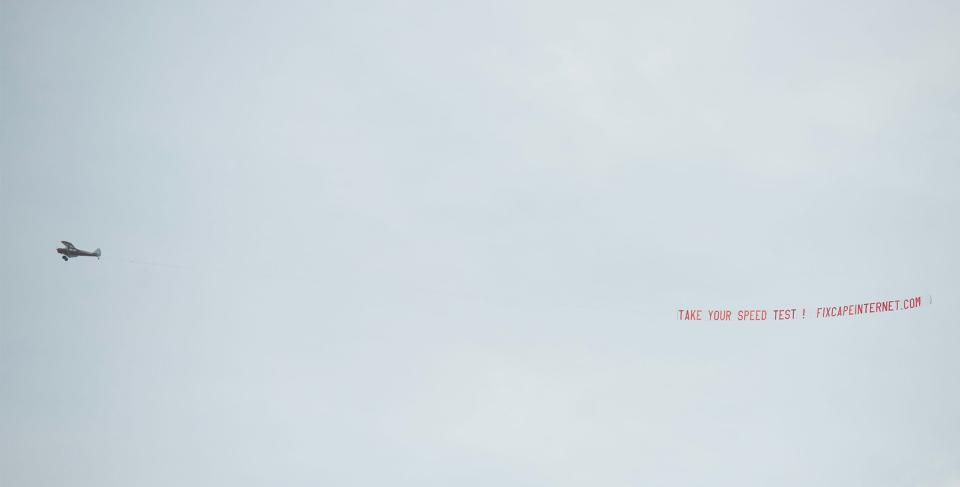 A plane tows a banner on June 26 over Hyannis to publicize a Fix Cape Internet initiative that organizers are using draw attention what they contend is a lack of high speed, affordable internet service for downtown businesses.