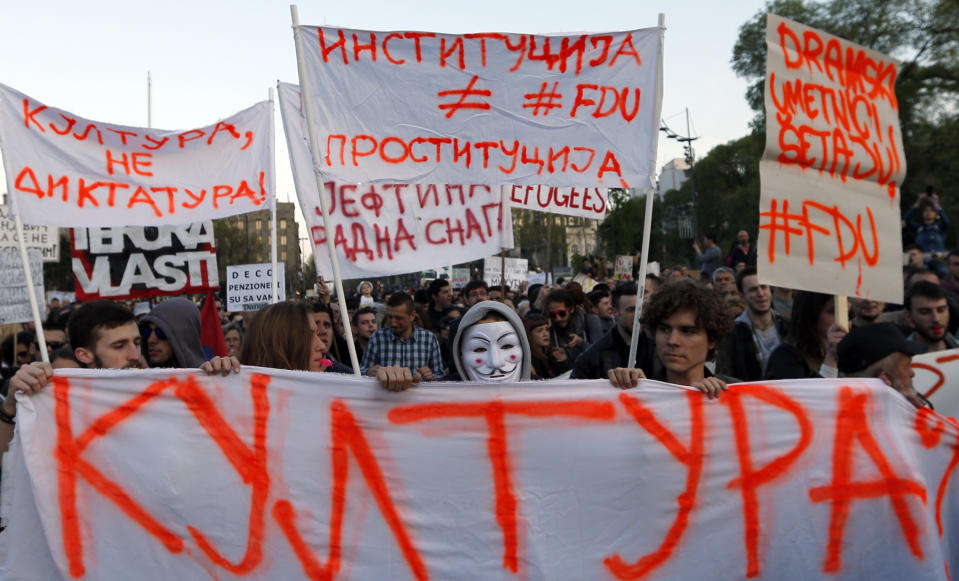 Protesters march holding banners: "Culture?", down, "Culture, no dictatorship!", top left, "Institution is not prostitution", top center and "Drama artists are walking!", during a protest in Belgrade, Serbia, Sunday, April 9, 2017. Thousands of people have protested for the seventh consecutive day against the presidential election victory of Serbia's powerful Prime Minister Aleksandar Vucic, amid fresh allegations by the opposition of a rigged vote count. (AP Photo/Darko Vojinovic)