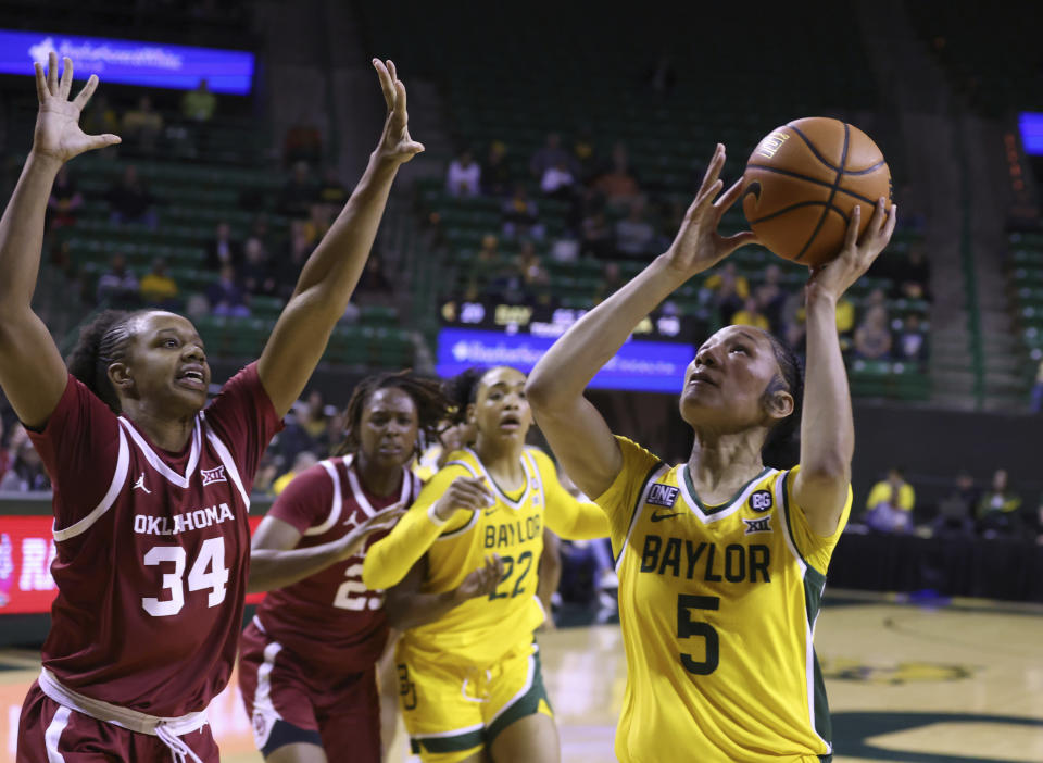 Baylor guard Darianna Littlepage-Buggs (5) shoots past Oklahoma forward Liz Scott (34) during the first half of an NCAA college basketball game Tuesday, Feb. 7, 2023, in Waco, Texas. (Rod Aydelotte/Waco Tribune-Herald via AP)