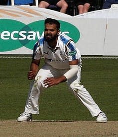 Azeem Rafiq on pitch stands ready to catch ball.