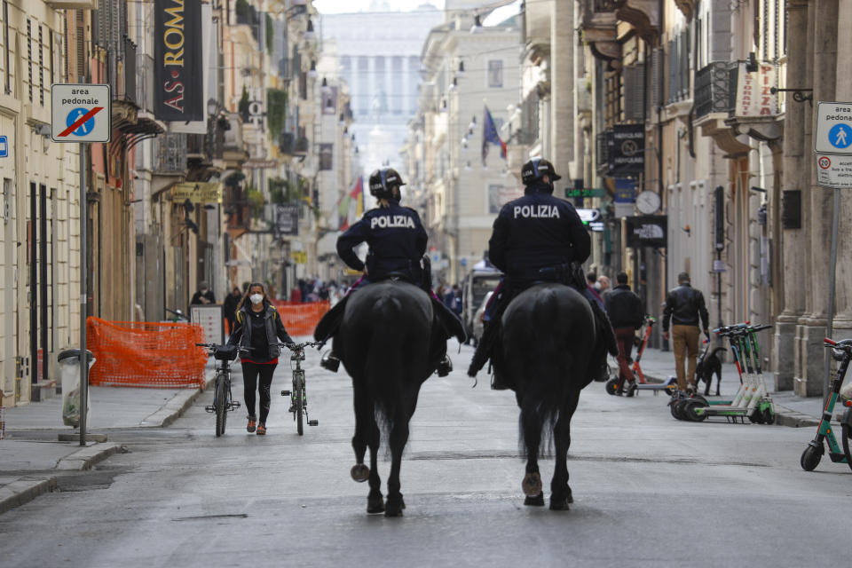 Mounted police officers patrol Via del Corso main shopping street, in downtown Rome, Saturday, April 3, 2021. Italy went into lockdown on Easter weekend in its effort to battle then Covid-19 pandemic. (AP Photo/Gregorio Borgia)