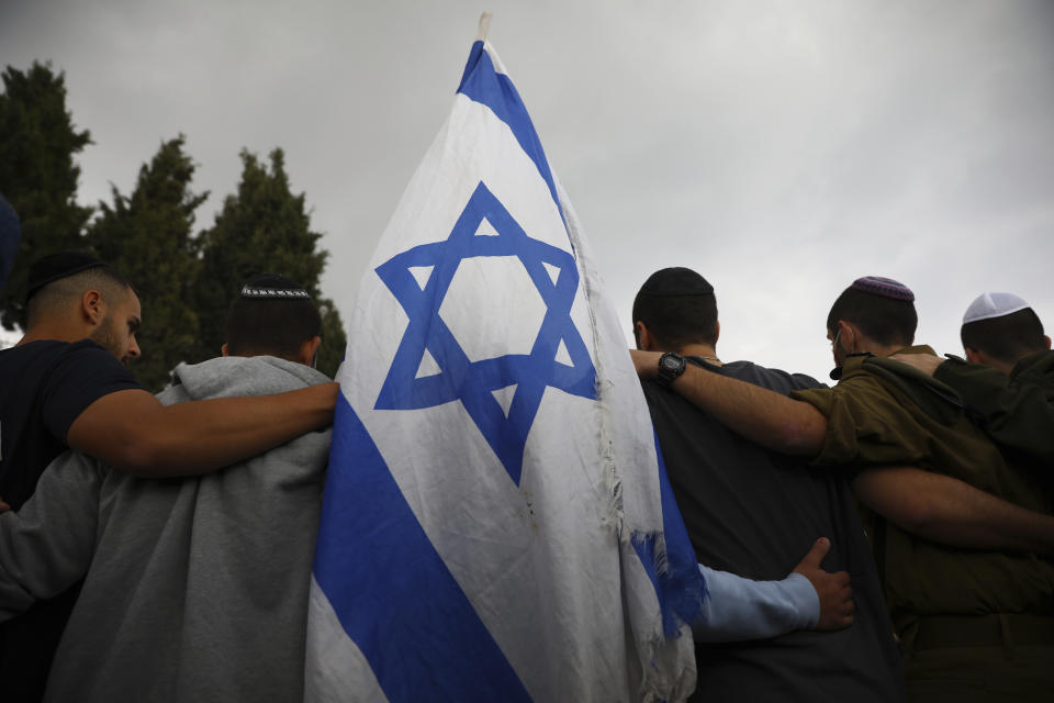 Mourners gather at the funeral for Eliyahu Kay, a 26-year-old immigrant to Israel from South Africa, the day after he was killed when a Palestinian man opened fire in the Old City of Jerusalem, Monday, Nov. 22, 2021, in Jerusalem. (AP Photo/Oded Balilty)