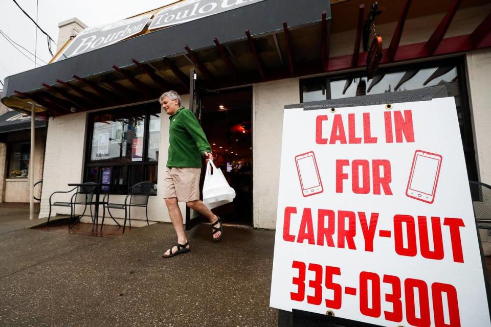 Scott Black leaves with a to-go order Wednesday evening from Bourbon ‘n’ Toulouse in the Chevy Chase neighborhood in March 2020. Bourbon ‘n’ Toulouse and many other Lexington restaurants switched to carryout options during the pandemic and those proved very popular.