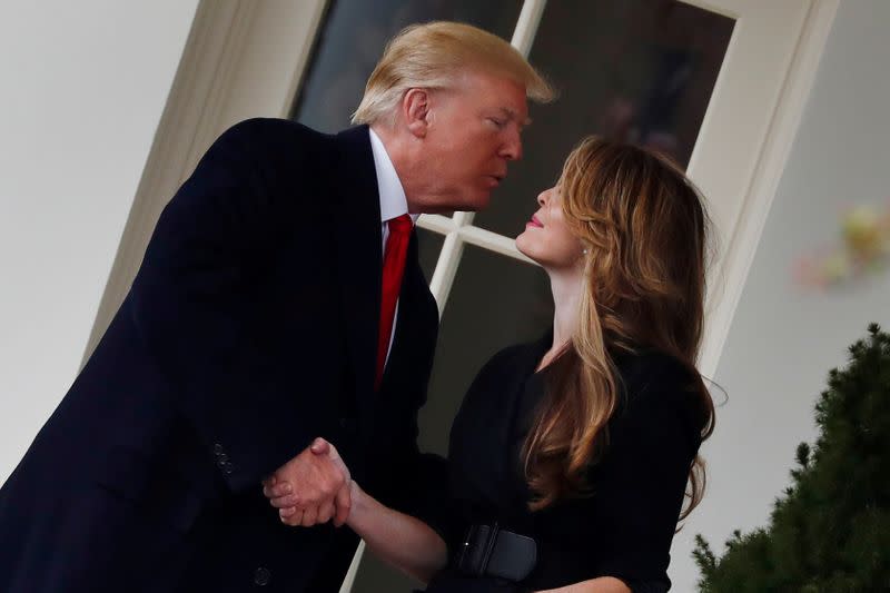 FILE PHOTO: U.S. President Donald Trump shakes hands with former White House Communications Director Hope Hicks outside of the Oval Office as he departs the White House for a trip to Cleveland, Ohio, in Washington D.C.