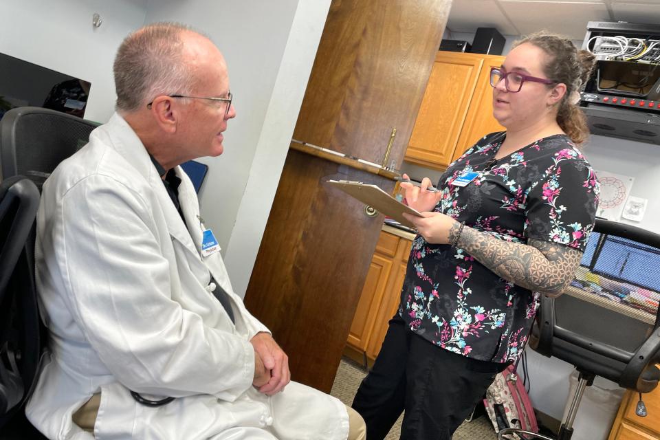 Volunteer physician Dr. William Liston talks with Cora Sternberg, nurse operations manager at the HOPE Medical Clinic in Destin. HOPE Medical Clinic has about 5,000 active patients served from offices in Destin and Freeport.