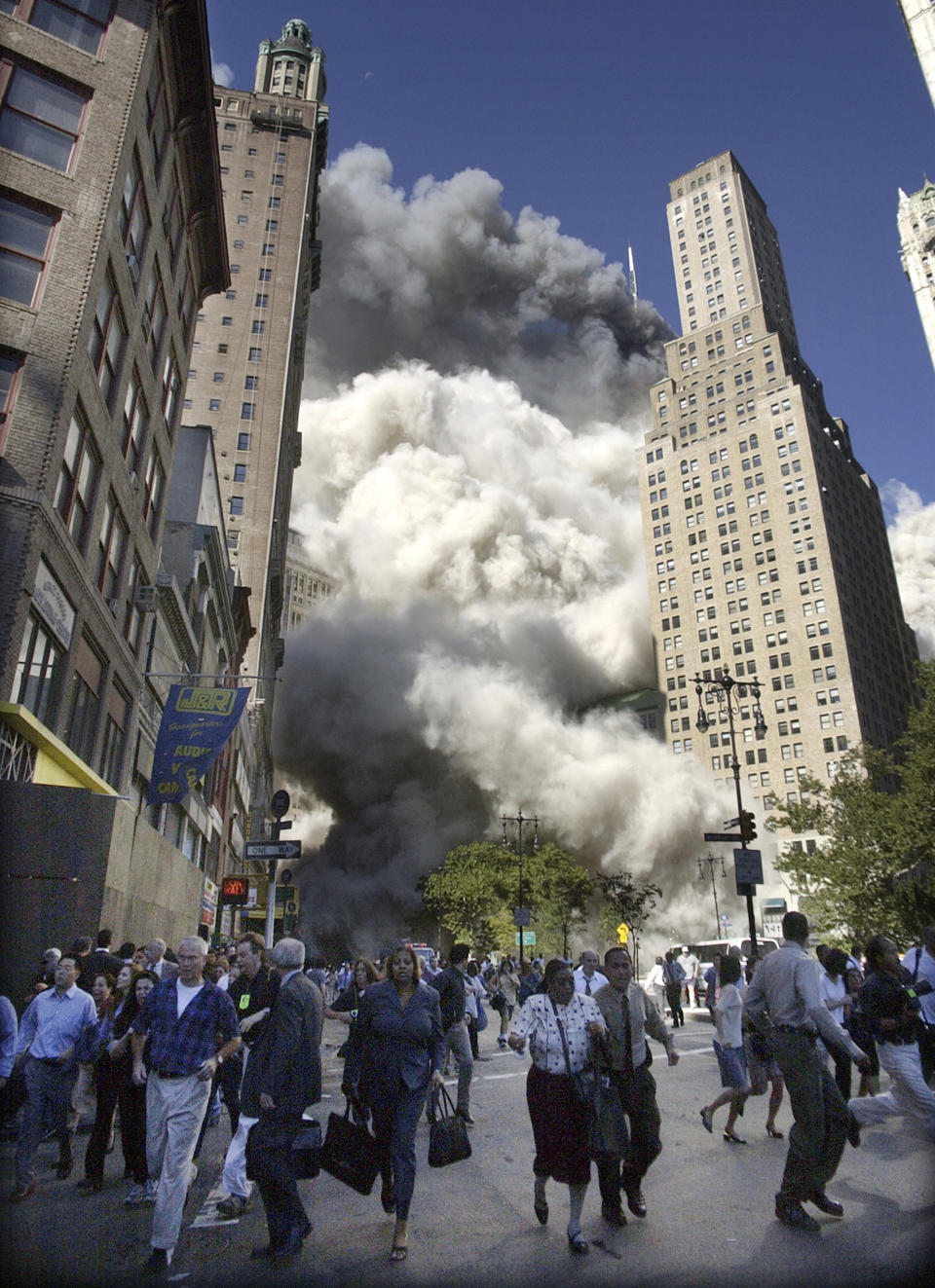 <p>People flee the falling South Tower of the World Trade Center on Tuesday, Sept. 11, 2001. (AP Photo/Amy Sancetta)</p> 