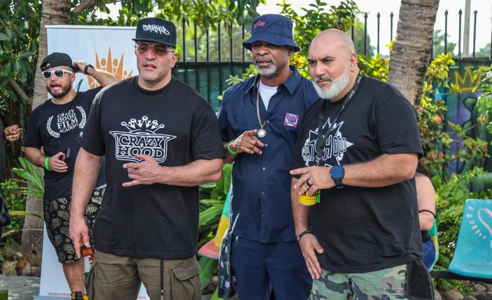 Eric Narciandi (far right) a.k.a. DJ EFN poses with Miami legend rapper JT Money (center) and Charles Rivero, during an event to celebrate the Crazy Hood Productions 30th anniversary at La esquina de la Abuela space in Miami, on December 02, 2023.