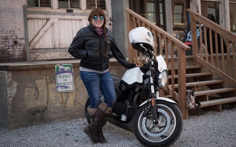 Stephanie Hartman, 29, with her 2007 Harley Davidson Buell Blast outside Blip, a cafe which doubles as a bike shop - Credit: Neville Elder for The Telegraph