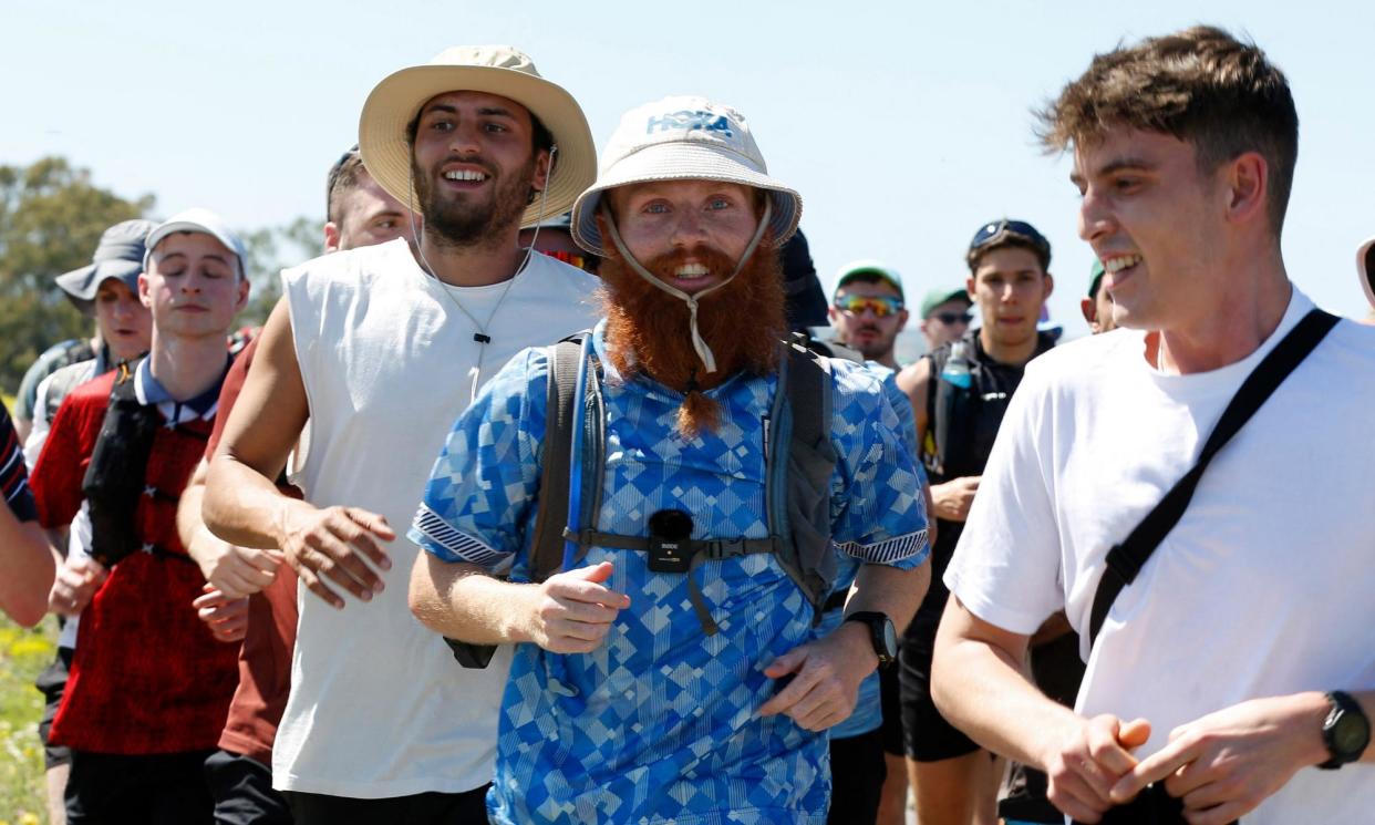 <span>Russ Cook (centre) in the closing stages of his run along the length of Africa.</span><span>Photograph: Zoubeir Souissi/Reuters</span>