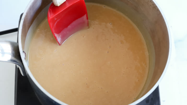 stirring caramel mixture in pan