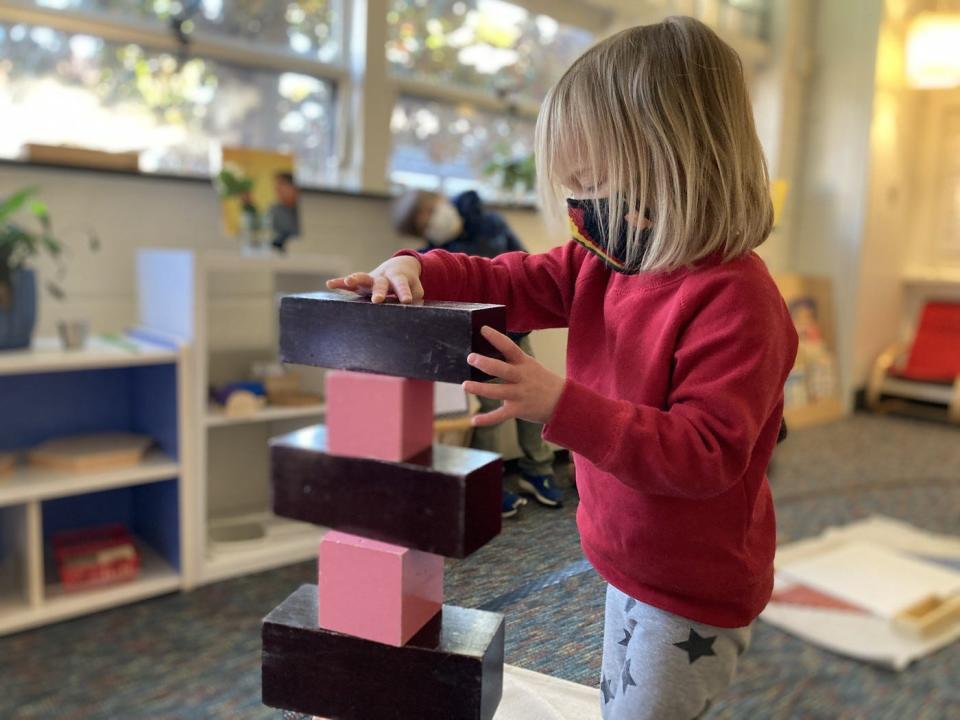 Hazel Mullinax-Wilson stacks blocks in her Asheville Primary School classroom.