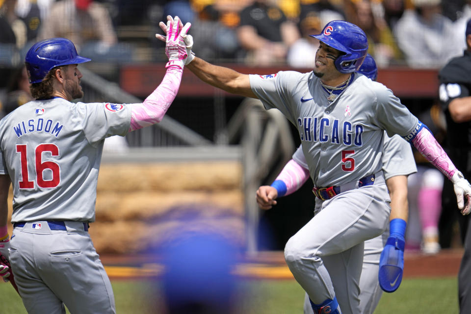 Chicago Cubs' Christopher Morel (5) celebrates with Patrick Wisdom (16) as he returns to the dugout after hitting a two-run home run off Pittsburgh Pirates starting pitcher Bailey Falter during the first inning of a baseball game in Pittsburgh, Sunday, May 12, 2024. (AP Photo/Gene J. Puskar)